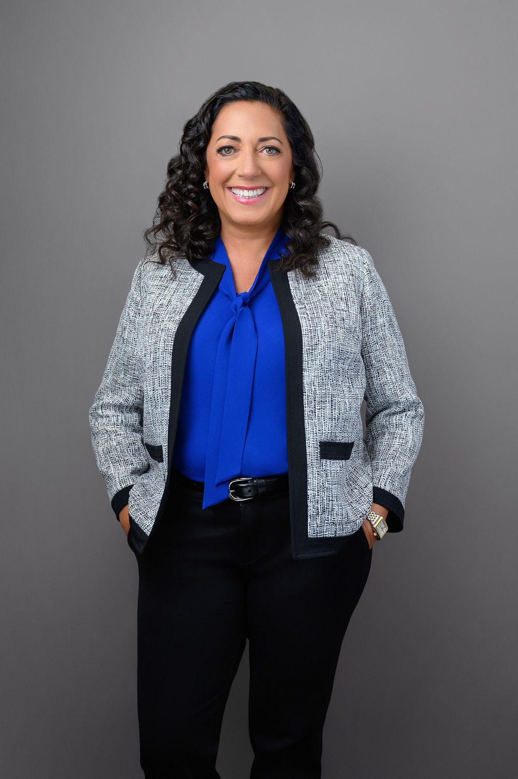 Professional headshot of Dr. Georgetta Parisi, a senior executive woman in a gray blazer and blue blouse photographed in New Jersey